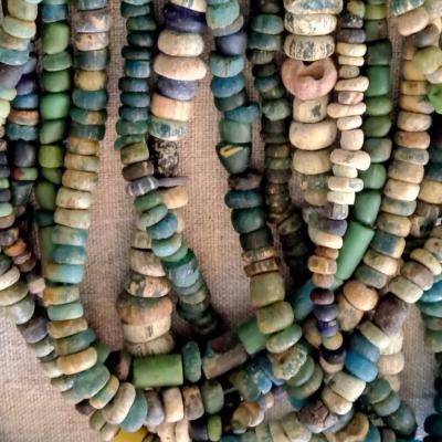 Large collection of strings of glass beads, originating from the Syrian region and produced in the 14-17th Cent. Beautiful blue colour, some beads are worn on the surface. Found in former homesteads in Central-Mali.