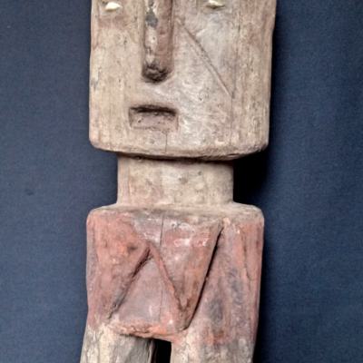 Large figure of a female, used as an ancestoral statue on family altars, Decorated with iron pigment,clay and two small shells for eyes. Height.;36 cm. Ewe.Togo.